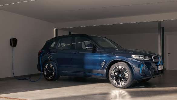 Recharge sur le lieu de travail – BMW iX3 à une station de recharge dans un garage
