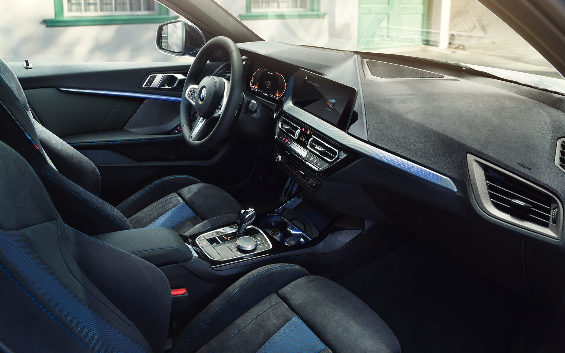 Intérieur sportif de la BMW Série 1 F40 Le poste de conduite de la BMW Série 1 F40 avec sièges M sport, volant M en cuir et inserts de décoration éclairés.